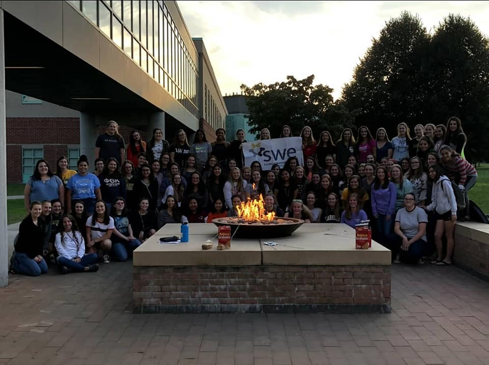 Students in front of the fire at the student center