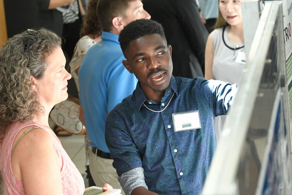 A student presenting their research at an on campus event