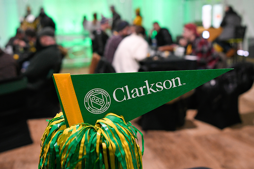 Clarkson pennant with blurred people interacting in the background
